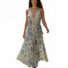 Woman wearing blue and ivory block print halter maxi dress with V-neck and tie waist. Flowy resort wear dress for Florida, Miami, or beach vacation