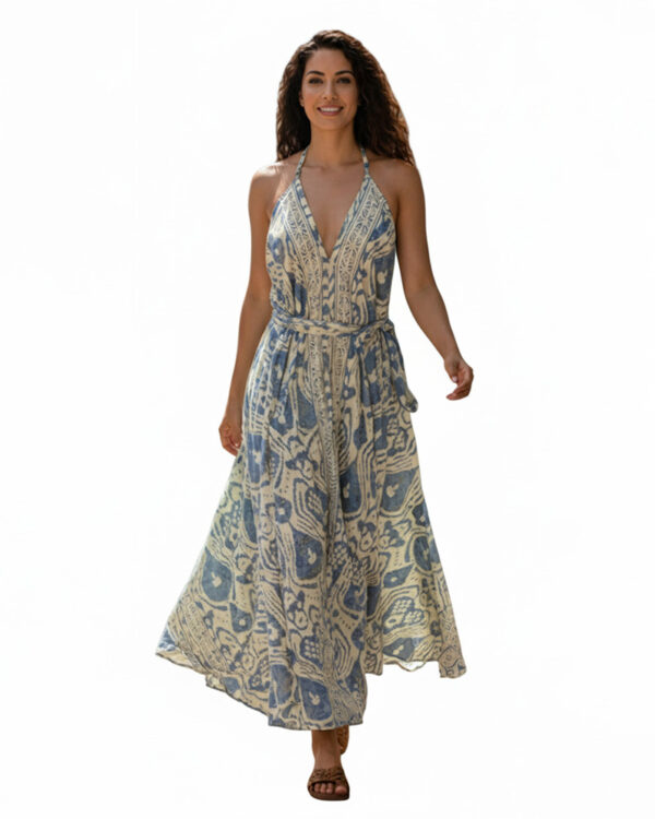 Woman wearing blue and ivory block print halter maxi dress with V-neck and tie waist. Flowy resort wear dress for Florida, Miami, or beach vacation