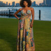 Woman with curly hair wearing a blue paisley tiered boho maxi dress with a V-neck and smocked waist