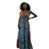 Woman with curly hair wearing a blue paisley tiered boho maxi dress with a V-neck and smocked waist, posing against a white background